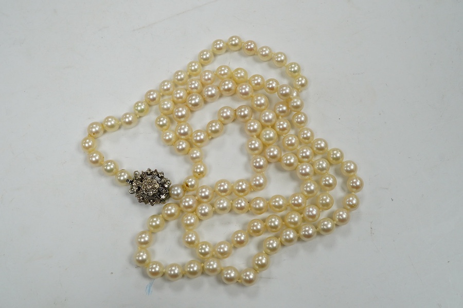 A single strand cultured pearl necklace, with diamond chip set white metal clasp, 88cm. Condition - fair to good